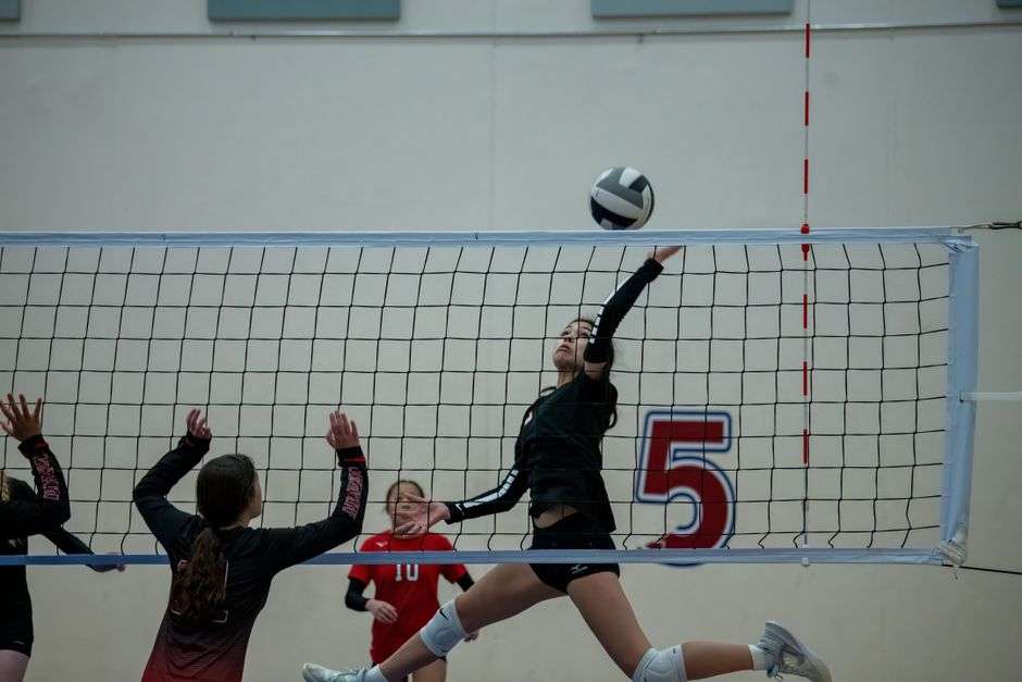 volleyball athletes encouraging teammate during match