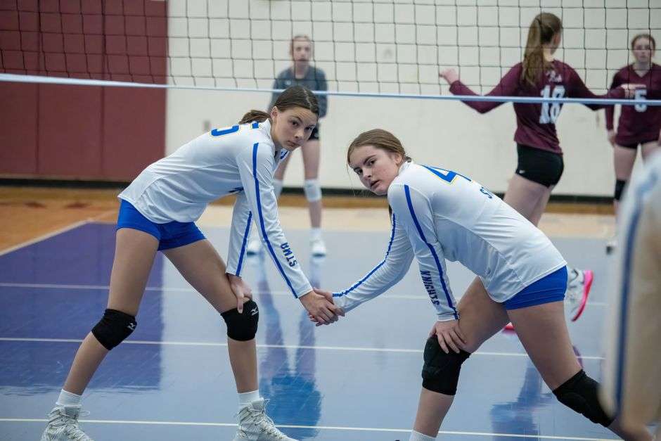 volleyball teammates high five positive energy